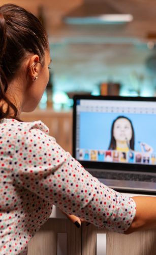 Professional graphic editor retouching Professional graphic editor retouching photos of a client during night time in home office. Photographer doing portrait post production using software and performance laptop, artist, occupation, screen, graphic