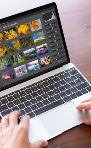 Man editing photo files on laptop computer Man editing photo files on laptop computer